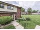 Attractive townhouse with brick accents, lawn, and inviting entrance creates curb appeal at 57 Trails End St, Greenwood, IN 46142