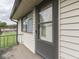 The front door features a storm door and exterior siding, adding to the home's curb appeal at 57 Trails End St, Greenwood, IN 46142