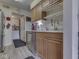 Well-maintained kitchen area with wood cabinetry, stainless steel dishwasher, and adjacent door to laundry at 57 Trails End St, Greenwood, IN 46142