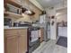 Functional kitchen boasts wooden cabinets, up-to-date appliances, and easy access to an adjacent room at 57 Trails End St, Greenwood, IN 46142