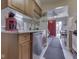 Bright kitchen showcasing wood cabinetry, stainless steel dishwasher, and seamless flow to an adjacent dining area at 57 Trails End St, Greenwood, IN 46142