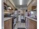 Efficient kitchen with wooden cabinets, modern appliances and great layout to laundry through an adjacent doorway at 57 Trails End St, Greenwood, IN 46142