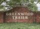 Community entrance sign displaying 'Greenwood Trails' amid lush greenery at 57 Trails End St, Greenwood, IN 46142