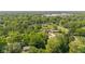 An aerial shot captures a neighborhood with tree-lined streets and green lawns at 5843 N Oakland Ave, Indianapolis, IN 46220