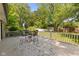 Expansive back deck with a dining set surrounded by lush greenery, perfect for outdoor gatherings at 5843 N Oakland Ave, Indianapolis, IN 46220