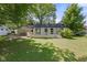 Well-maintained backyard features a wooden deck and lush lawn, perfect for outdoor activities and relaxation at 5843 N Oakland Ave, Indianapolis, IN 46220
