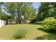 Expansive backyard featuring a storage shed, mature trees and a lush lawn, creating a serene outdoor space at 5843 N Oakland Ave, Indianapolis, IN 46220