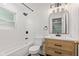 Bright bathroom featuring white subway tile, a modern vanity with a light wood finish, and contemporary fixtures at 5843 N Oakland Ave, Indianapolis, IN 46220