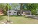 Charming single-story home featuring a well-maintained lawn and beautiful mature trees at 5843 N Oakland Ave, Indianapolis, IN 46220