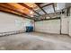 Spacious garage with exposed ceiling beams and room for parking and storage at 5843 N Oakland Ave, Indianapolis, IN 46220