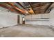 Spacious garage with exposed ceiling beams and room for parking and storage at 5843 N Oakland Ave, Indianapolis, IN 46220