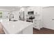 Bright kitchen with a large white quartz island and stainless steel appliances at 5843 N Oakland Ave, Indianapolis, IN 46220