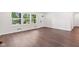 Bright living area showcasing wood-look floors, fresh paint, and an abundance of natural light at 5843 N Oakland Ave, Indianapolis, IN 46220