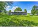 Well-maintained backyard with expansive lawn, mature trees, and a charming home exterior at 5941 North St, Stilesville, IN 46180
