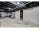 Spacious unfinished basement with painted ceilings and concrete floors, ready for customization at 5941 North St, Stilesville, IN 46180