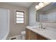 Bathroom with a modern vanity, marble floors, and a window at 5941 North St, Stilesville, IN 46180