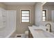 Bathroom featuring a bathtub with white paneling, a modern vanity, and a bright window at 5941 North St, Stilesville, IN 46180