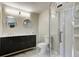 Modern bathroom with a double sink vanity, marble floors, and glass enclosed shower at 5941 North St, Stilesville, IN 46180