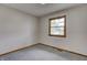 Neutral bedroom with a window offering natural light and plush gray carpet at 5941 North St, Stilesville, IN 46180