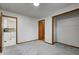 Bedroom featuring neutral walls, gray carpet, closet, and doorway to kitchen at 5941 North St, Stilesville, IN 46180