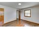 Spacious bedroom with hardwood floors, neutral walls, and ample natural light from the window, creating a serene ambiance at 5941 North St, Stilesville, IN 46180