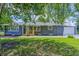 Charming single-story home with gray siding, a welcoming wooden porch, well-maintained lawn, and an attached garage at 5941 North St, Stilesville, IN 46180