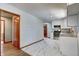Modern kitchen with white cabinets, granite countertops, stainless steel appliances, and stylish tile flooring at 5941 North St, Stilesville, IN 46180