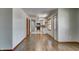 Open-concept layout featuring hardwood floors and seamless flow into a kitchen with white cabinets and stainless steel appliances at 5941 North St, Stilesville, IN 46180