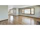 Bright living room with gleaming hardwood floors and ample natural light, seamlessly flowing into the adjacent spaces at 5941 North St, Stilesville, IN 46180