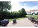 Paver patio with outdoor dining set, fire pit, and grill, perfect for entertaining and enjoying the backyard at 635 Sonoma Ln, Greenfield, IN 46140