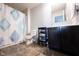 Bright bathroom featuring a black vanity, stylish tile floor, and a shower with a decorative blue shower curtain at 635 Sonoma Ln, Greenfield, IN 46140