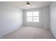 Minimalist bedroom with neutral carpet, ceiling fan, window for natural light, and neutral paint at 635 Sonoma Ln, Greenfield, IN 46140