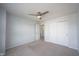Bright bedroom features neutral carpeting, a ceiling fan, and a closet with traditional sliding doors at 635 Sonoma Ln, Greenfield, IN 46140