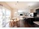 Open-concept dining area connected to kitchen and living room with access to the backyard at 635 Sonoma Ln, Greenfield, IN 46140