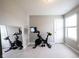 Exercise room featuring neutral carpeting, a Peloton exercise bike, and a full length mirror at 635 Sonoma Ln, Greenfield, IN 46140