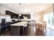 Bright kitchen boasts stainless steel appliances, dark cabinetry, and a large island with bar seating at 635 Sonoma Ln, Greenfield, IN 46140