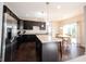 Bright kitchen features stainless steel appliances, dark cabinetry, and a center island at 635 Sonoma Ln, Greenfield, IN 46140