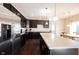 Bright kitchen featuring stainless steel appliances, a center island, and dark cabinetry at 635 Sonoma Ln, Greenfield, IN 46140