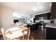 Open-concept kitchen and dining area with dark cabinets and center island at 635 Sonoma Ln, Greenfield, IN 46140