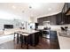Open-concept kitchen with a breakfast bar, stainless steel appliances, and hardwood floors at 635 Sonoma Ln, Greenfield, IN 46140