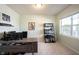 Bright home office with a large desk, bookshelf, and natural light from a window at 635 Sonoma Ln, Greenfield, IN 46140