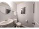 Stylish powder room features a pedestal sink and modern artwork at 635 Sonoma Ln, Greenfield, IN 46140