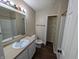 Well-maintained bathroom featuring a vanity, mirror, and open linen storage at 6715 Shanghai Cir, Indianapolis, IN 46278