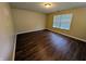 Comfortable bedroom with wood flooring, neutral paint, and natural light at 6715 Shanghai Cir, Indianapolis, IN 46278