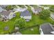 This aerial view captures the home's large, fenced yard, patio, shed, mature tree, and neighborhood layout at 6822 Woodford Ln, Indianapolis, IN 46237