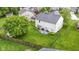 Aerial view of the property showcasing the expansive backyard, patio, and surrounding neighborhood at 6822 Woodford Ln, Indianapolis, IN 46237
