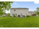 Sprawling backyard with a well-manicured lawn, patio with a grill, and privacy fence at 6822 Woodford Ln, Indianapolis, IN 46237