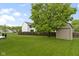 Lush backyard featuring a storage shed, beautiful shade tree, and a wood privacy fence at 6822 Woodford Ln, Indianapolis, IN 46237