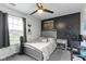 Cozy bedroom with gray walls, a ceiling fan, plush carpet, and a playful Tottenham Hotspur theme at 6822 Woodford Ln, Indianapolis, IN 46237