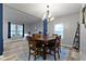 Dining room featuring hardwood floors, natural light, and an open layout to the living spaces at 6822 Woodford Ln, Indianapolis, IN 46237